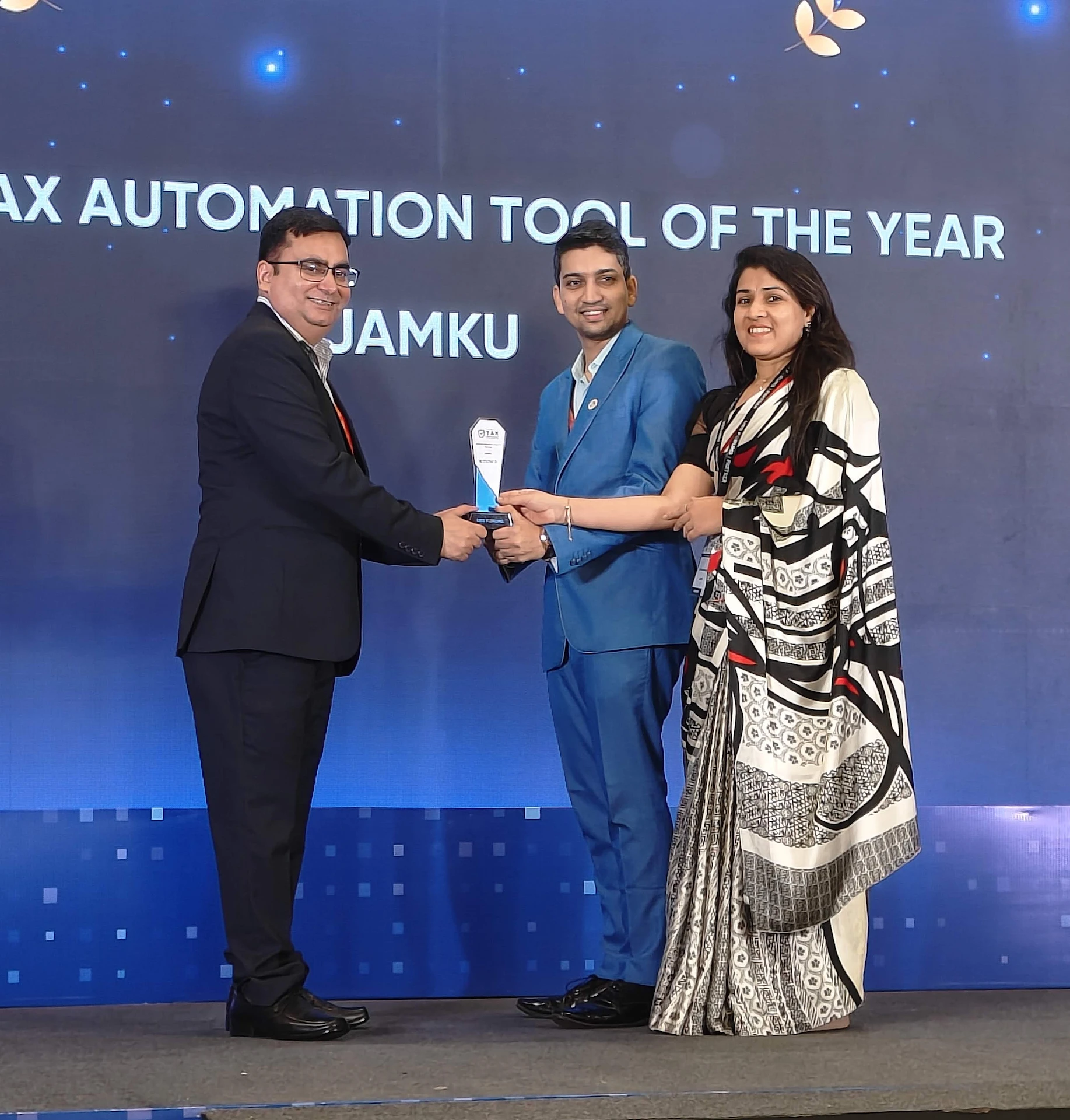 Presenters handing the Best Tax Automation Tool of the Year trophy to the winners at the award ceremony in Delhi
